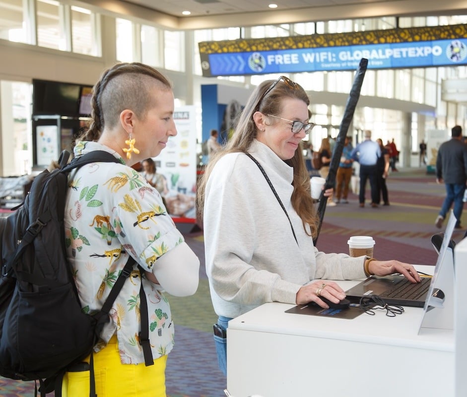 Two Attendees at Self-Service Badge Pick Up at Global Pet Expo