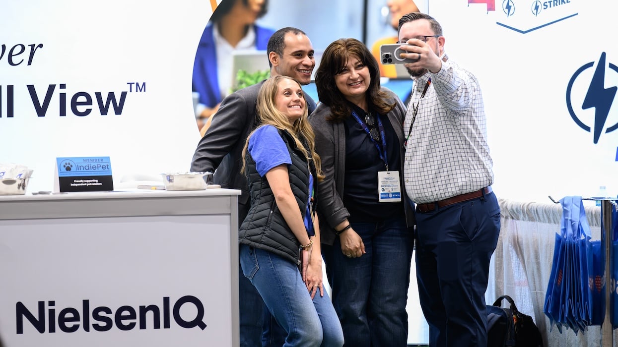 Suppliers taking a selfie at Global Pet Expo