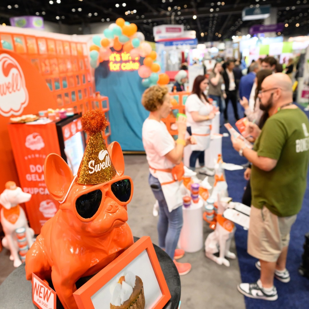 People interacting at the Swell booth at Global Pet Expo 2025